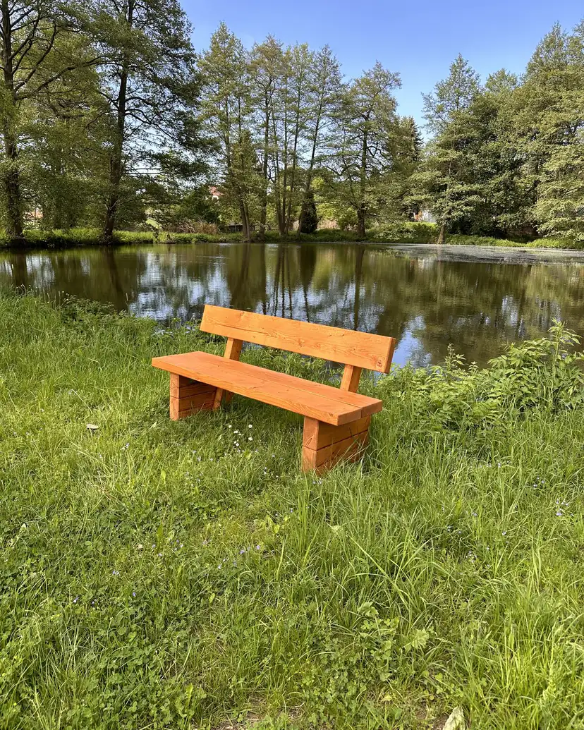 Massivholzbank in natürlicher Umgebung, seitliche Ansicht